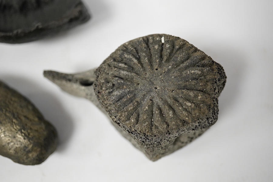 Five fossilised whale ear drums, largest 9cm long. Condition - mostly fair to good, one with small break